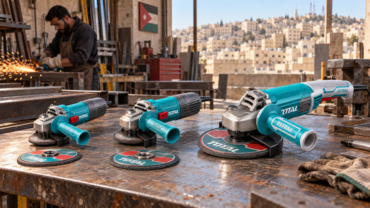 Three angle grinders, 115mm, 125mm and 230mm, on a steel workbench with cutting discs
