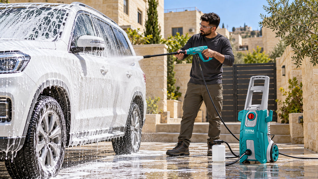 Man washing a foam-covered SUV in a driveway with an electric pressure washer